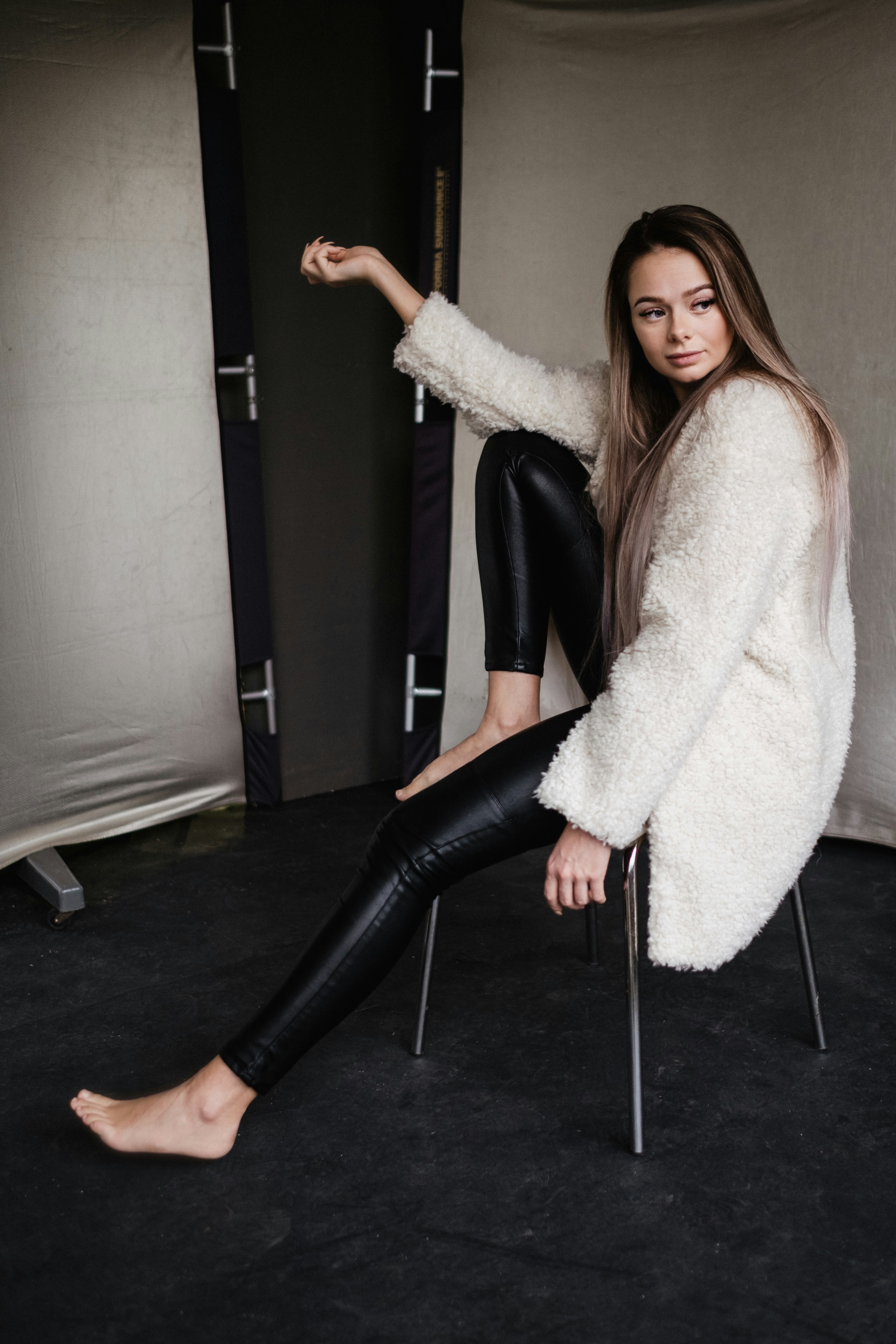 woman in white fur coat and black pants